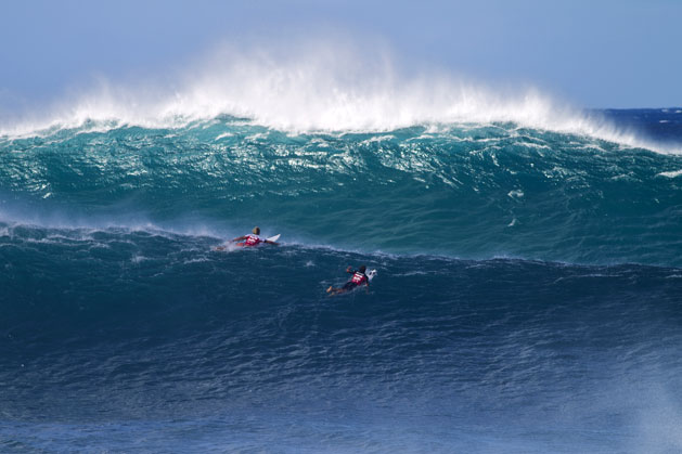 Surfers paddle at The Billabong Pipe Masters